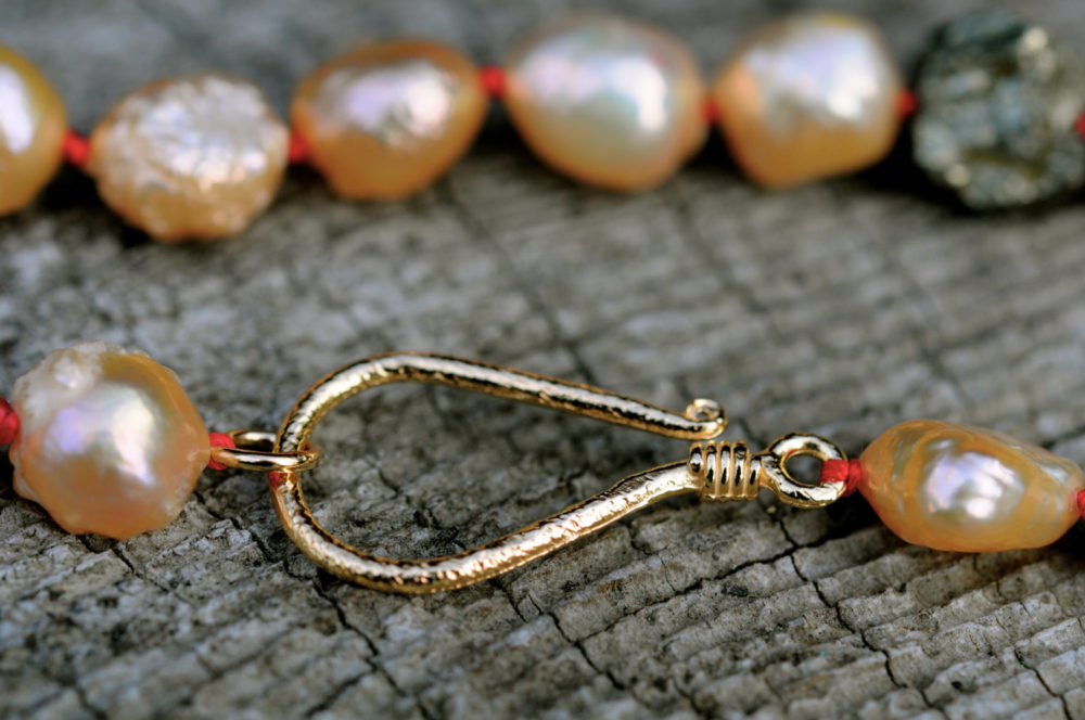 a prosperous necklace, golden druzy pearls and shimmering chunks of pyrite in bright red and gold links