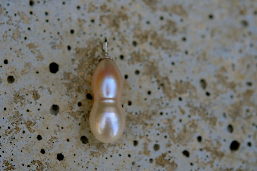unique shape blush pink/creamy white single pearl pendant, set on sterling silver